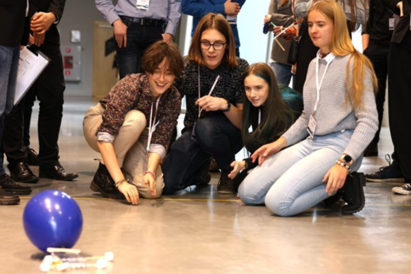 Four students testing their model of a lunar lander in competition held at Copernicus Science Centre.